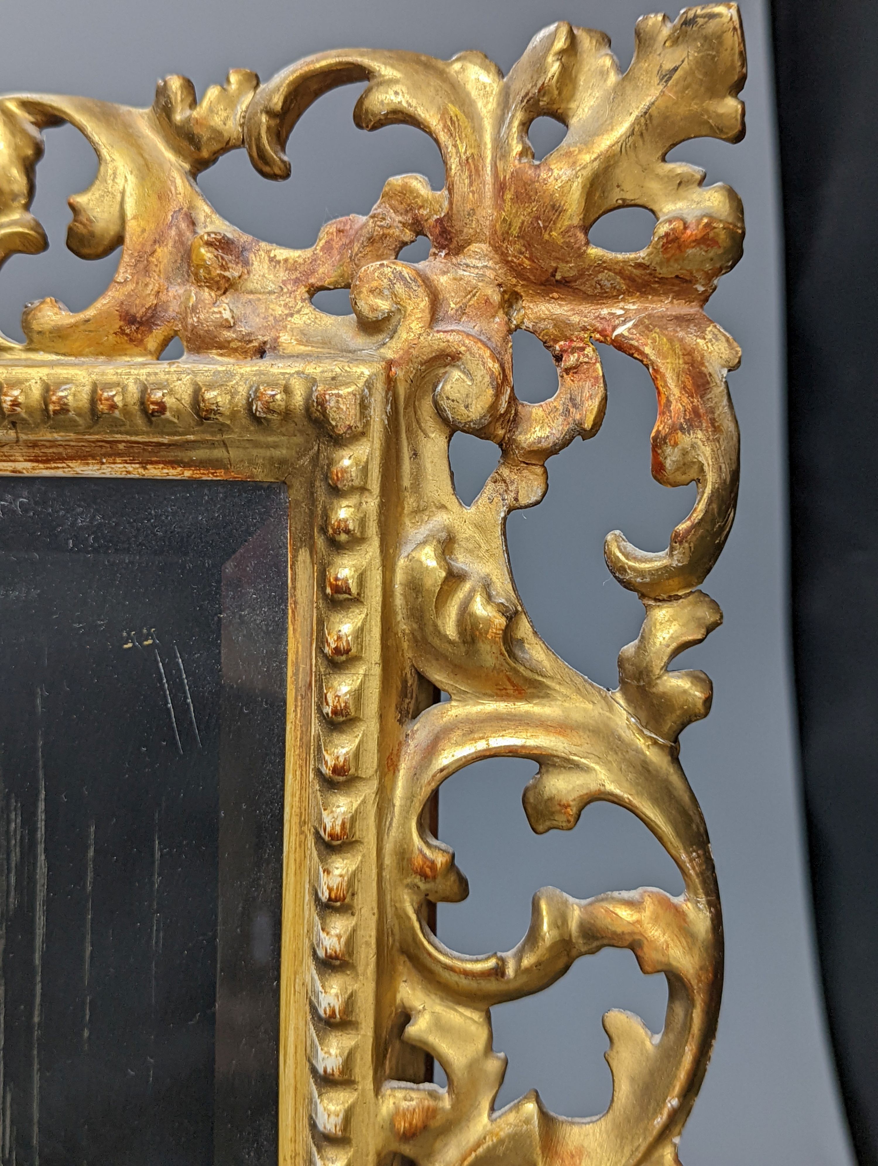 A Florentine giltwood framed mirror, with later easel back, 54 cms high x 43 cms wide.